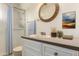 Neat bathroom featuring a vanity with storage, framed mirror, and shower at 5323 E Dodge St, Mesa, AZ 85205
