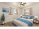 Comfortable bedroom with a ceiling fan, neutral walls and two sunny windows at 5323 E Dodge St, Mesa, AZ 85205