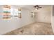 Bright and airy bedroom with tiled floors, ceiling fan, and large window at 5323 E Dodge St, Mesa, AZ 85205