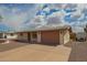 Exterior view of house, displaying front yard, driveway and two-car garage at 5323 E Dodge St, Mesa, AZ 85205