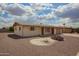 Charming single-story home with desert landscaping under a beautiful blue sky at 5323 E Dodge St, Mesa, AZ 85205