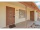 Inviting front porch featuring a security door, address number, and wrought iron supports at 5323 E Dodge St, Mesa, AZ 85205