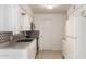 Functional kitchen with white cabinets, tiled backsplash, and essential appliances at 5323 E Dodge St, Mesa, AZ 85205