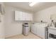 Functional laundry room with washer, dryer, and built-in storage at 5323 E Dodge St, Mesa, AZ 85205