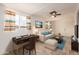 Bright and inviting living room with desk, couch and ceiling fan at 5323 E Dodge St, Mesa, AZ 85205