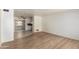 Open-concept living area with wood-look floors and a view into the kitchen at 5323 E Dodge St, Mesa, AZ 85205
