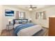 Cozy main bedroom with comfortable bed, ceiling fan, and two sunny windows at 5323 E Dodge St, Mesa, AZ 85205