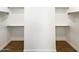 This is a very large walk-in closet with wood-look tile flooring and multiple shelves at 5719 E Santa Clara Dr, San Tan Valley, AZ 85140