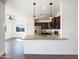 This kitchen has stainless appliances, dark cabinets, granite counters and pendant lights above the breakfast bar at 5719 E Santa Clara Dr, San Tan Valley, AZ 85140