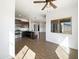 This open concept kitchen has stainless appliances and dark cabinets and overlooks the living and dining areas at 5719 E Santa Clara Dr, San Tan Valley, AZ 85140