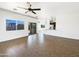 Spacious living room featuring hardwood floors, a ceiling fan, and an open layout leading to the kitchen at 5719 E Santa Clara Dr, San Tan Valley, AZ 85140