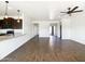 Open concept living space with kitchen, living room and dining area with wood-look tile throughout at 5719 E Santa Clara Dr, San Tan Valley, AZ 85140