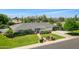Expansive aerial view of a well-maintained home with lush greenery, a large yard, and a driveway at 6231 E Calle Camelia --, Scottsdale, AZ 85251
