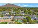 Aerial view of the home, showcasing the pool and the surrounding neighborhood with mountain views at 6231 E Calle Camelia --, Scottsdale, AZ 85251