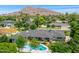 Aerial view of the home, showcasing the pool and surrounding neighborhood with mountain backdrop at 6231 E Calle Camelia --, Scottsdale, AZ 85251