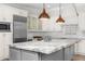 Bright kitchen with an oversized marble island, stainless appliances, and white cabinetry at 6231 E Calle Camelia --, Scottsdale, AZ 85251