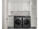 Well organized laundry room with black and white tile flooring, cabinets and washer/dryer at 6231 E Calle Camelia --, Scottsdale, AZ 85251