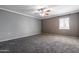 Large bedroom with ceiling fan, window and carpet at 6240 N 16Th St # 40, Phoenix, AZ 85016