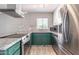 Cozy kitchen with stainless steel appliances and green cabinets at 6240 N 16Th St # 40, Phoenix, AZ 85016