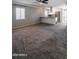 Spacious living room open to kitchen with carpet and ceiling fan at 6240 N 16Th St # 40, Phoenix, AZ 85016