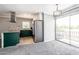 Open living room next to kitchen with door leading to balcony at 6240 N 16Th St # 40, Phoenix, AZ 85016