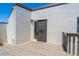 Private outdoor patio featuring a gray textured wall, metal gate door, and wood-look patio floor at 6240 N 16Th St # 40, Phoenix, AZ 85016