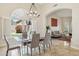 Elegant dining area with glass table, chandelier, and view to the outdoor with bright natural light at 6828 E Evans Dr, Scottsdale, AZ 85254