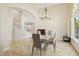 Bright dining room with chandelier, staircase and archways overlooking a glass dining table at 6828 E Evans Dr, Scottsdale, AZ 85254