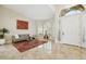 Inviting foyer with travertine flooring, arched doorway, and well-lit entry featuring a cozy seating area at 6828 E Evans Dr, Scottsdale, AZ 85254