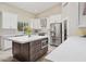 Bright kitchen featuring white cabinets, stainless steel appliances, and a central island with storage at 6828 E Evans Dr, Scottsdale, AZ 85254