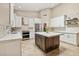 Well-equipped kitchen with stainless steel appliances, white countertops, and spacious center island at 6828 E Evans Dr, Scottsdale, AZ 85254