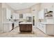 Stylish kitchen with white cabinetry, modern appliances, and a center island with quartz countertop at 6828 E Evans Dr, Scottsdale, AZ 85254