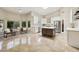 Bright kitchen featuring white cabinets, stainless appliances, and a central island with seating at 6828 E Evans Dr, Scottsdale, AZ 85254