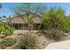 Well-maintained landscaping featuring desert plants, flowering shrubs, and accent lighting at 6828 E Evans Dr, Scottsdale, AZ 85254
