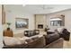 Comfortable living room features stone fireplace, ceiling fan and mount for TV viewing at 6828 E Evans Dr, Scottsdale, AZ 85254