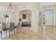 Open living space featuring travertine floors, dining, and living area with natural light from surrounding windows at 6828 E Evans Dr, Scottsdale, AZ 85254