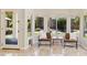 Sunlit sitting area with large windows offering views of the lush backyard at 6828 E Evans Dr, Scottsdale, AZ 85254