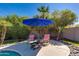 Outdoor seating area with a fire pit, surrounded by desert landscaping and a patio by the pool at 7053 S Heather Dr, Tempe, AZ 85283