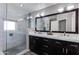Modern bathroom featuring a double vanity, glass shower, and sleek tile accents at 7053 S Heather Dr, Tempe, AZ 85283