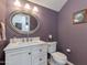 Cozy half-bathroom features a white vanity, oval mirror, and stylish wall color at 7053 S Heather Dr, Tempe, AZ 85283