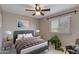 Comfortable bedroom with ceiling fan, a window for natural light, and minimalist furniture at 7053 S Heather Dr, Tempe, AZ 85283