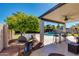 Covered outdoor patio with dining set, barbecue and view of the backyard pool at 7053 S Heather Dr, Tempe, AZ 85283