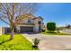 Charming two-story home featuring a well-manicured lawn and beautiful desert landscaping at 7053 S Heather Dr, Tempe, AZ 85283
