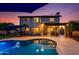Backyard view featuring a pool, covered patio, and a two-story house at twilight at 7053 S Heather Dr, Tempe, AZ 85283