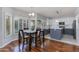 Eat-in kitchen with dark wood flooring, a dining table set, and gray and white cabinetry at 7053 S Heather Dr, Tempe, AZ 85283