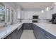 Bright kitchen featuring white cabinets, stainless steel appliances, and a farmhouse sink at 7053 S Heather Dr, Tempe, AZ 85283