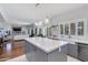 Open concept kitchen with a gray kitchen island, white countertops, and modern pendant lighting at 7053 S Heather Dr, Tempe, AZ 85283