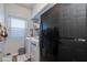 Bright laundry room with washer, dryer, shelving, and adjacent refrigerator at 7053 S Heather Dr, Tempe, AZ 85283