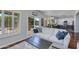 Bright living room featuring a modern sofa, sliding glass doors to backyard, and opening to the kitchen at 7053 S Heather Dr, Tempe, AZ 85283