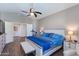 Spacious bedroom featuring a blue bed set, ceiling fan, and white nightstands at 7053 S Heather Dr, Tempe, AZ 85283